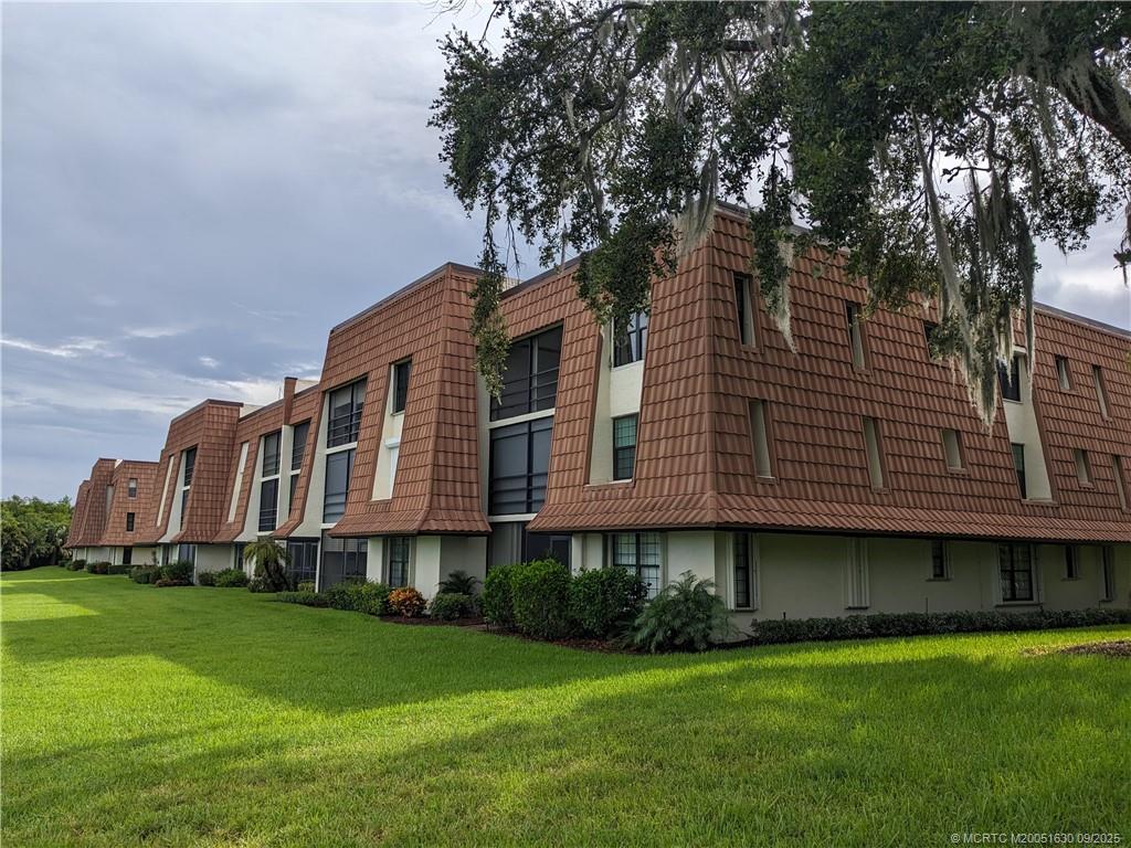 3100 Southeast Pruitt Road, Unit E204 Port St. Lucie, FL 34952 - Photo 20 of 40 a front view of a house with garden