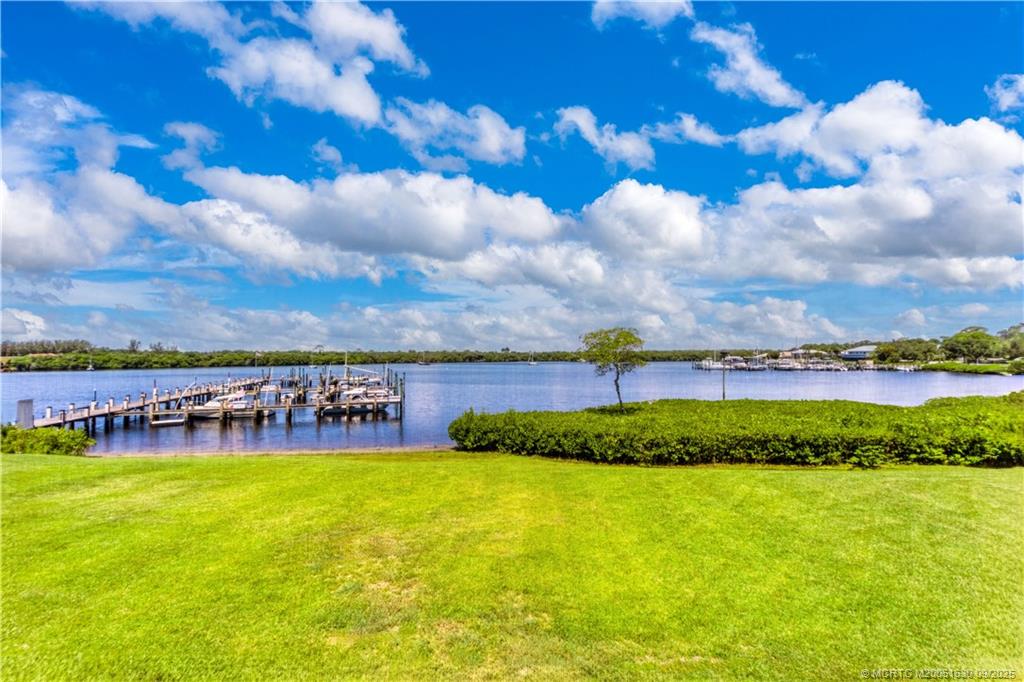 3100 Southeast Pruitt Road, Unit E204 Port St. Lucie, FL 34952 - Photo 2 of 40 a view of a city with lawn chairs and a large tree