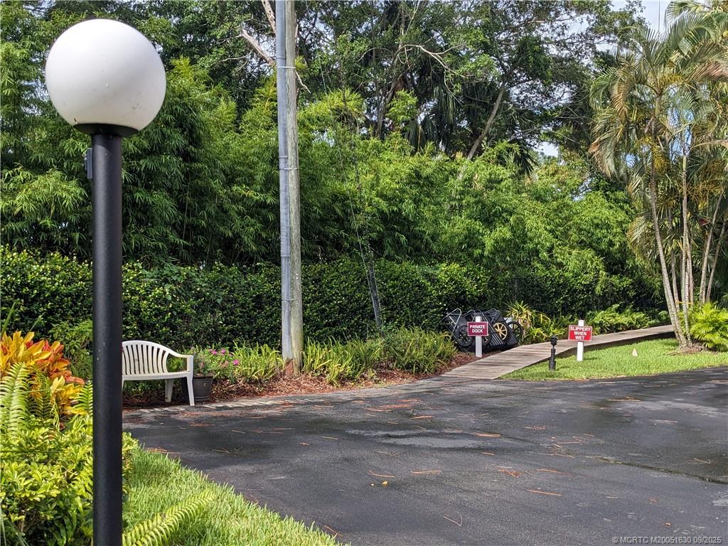 3100 Southeast Pruitt Road, Unit E204 Port St. Lucie, FL 34952 - Photo 21 of 40 a view of a park that has a street sign and a small yard