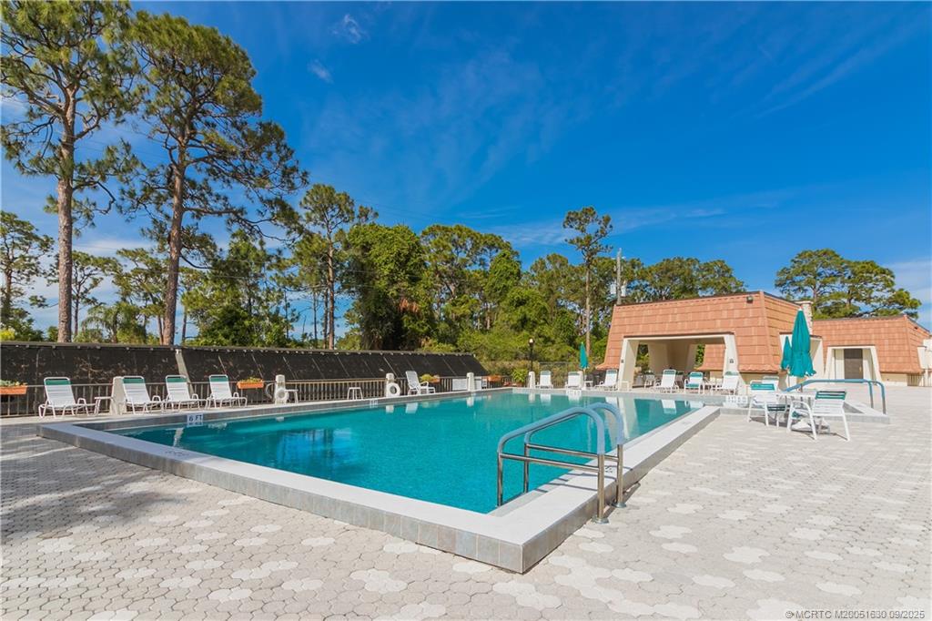 3100 Southeast Pruitt Road, Unit E204 Port St. Lucie, FL 34952 - Photo 33 of 40 a view of a house with outdoor space and sitting area