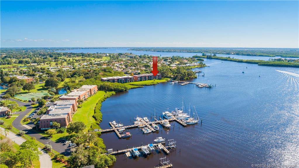 3100 Southeast Pruitt Road, Unit E204 Port St. Lucie, FL 34952 - Photo 4 of 40 an aerial view of a house with a swimming pool yard and outdoor seating