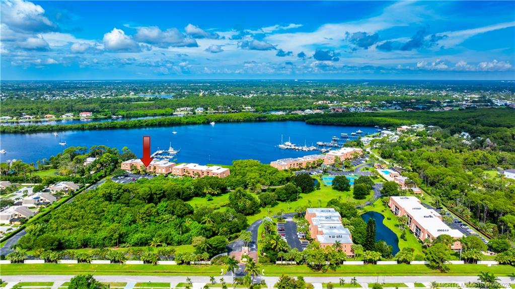 3100 Southeast Pruitt Road, Unit E204 Port St. Lucie, FL 34952 - Photo 5 of 40 a view of a city with lots of residential buildings ocean and mountain view in back