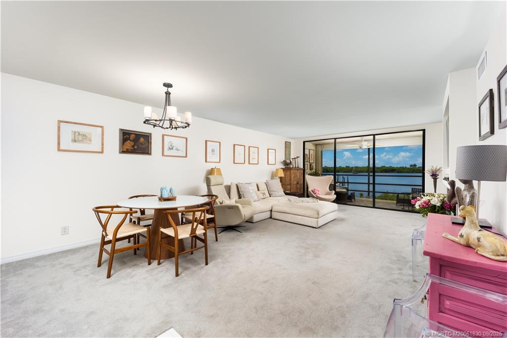 3100 Southeast Pruitt Road, Unit E204 Port St. Lucie, FL 34952 - Photo 9 of 40 a living room with furniture and a lamp