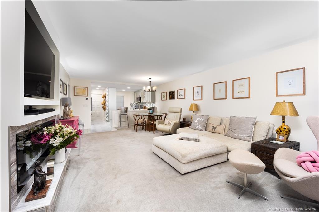 3100 Southeast Pruitt Road, Unit E204 Port St. Lucie, FL 34952 - Photo 10 of 40 a living room with furniture and a flat screen tv