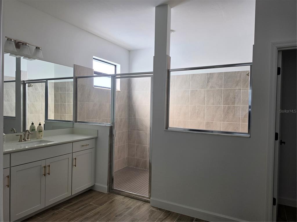 18334 Ridgeline Drive Estero, FL 33928 - Photo 10 of 30 a bathroom with a granite countertop sink mirror and double