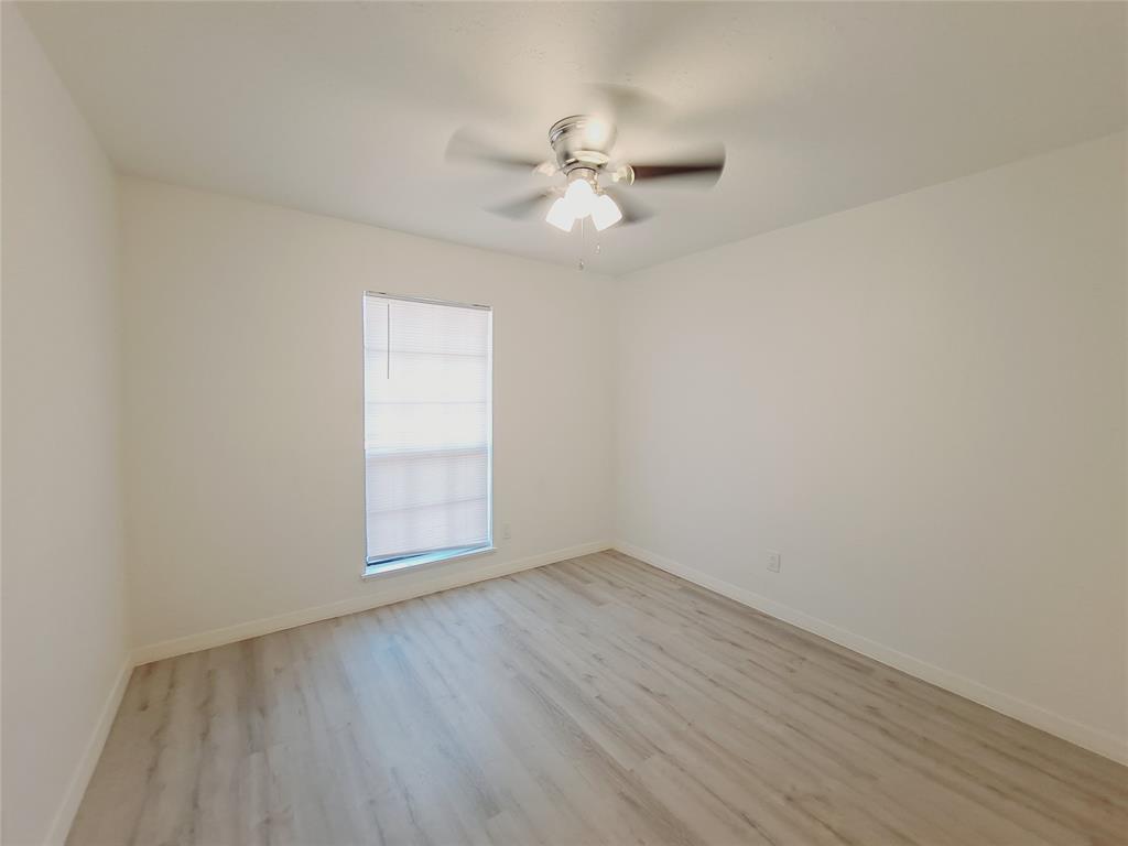 627 Valley View Drive Allen, TX 75002 - Photo 11 of 22 wooden floor in an empty room with a window