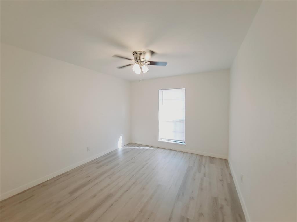 627 Valley View Drive Allen, TX 75002 - Photo 13 of 22 an empty room with a window and a ceiling fan