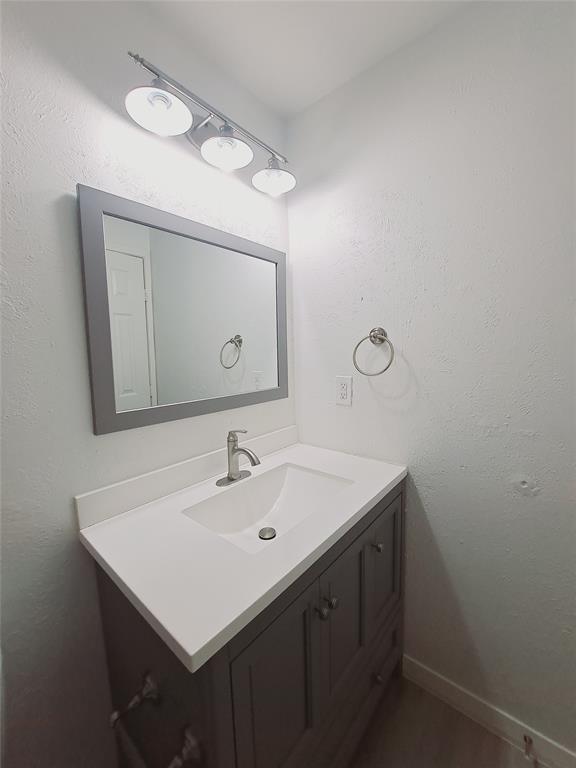 627 Valley View Drive Allen, TX 75002 - Photo 14 of 22 a bathroom with a sink and a mirror