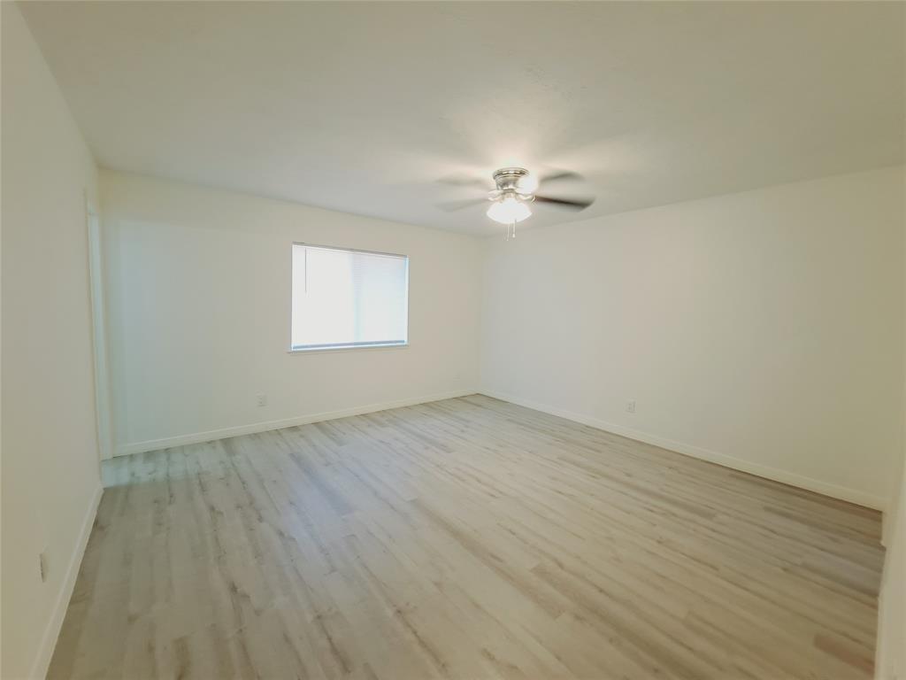 627 Valley View Drive Allen, TX 75002 - Photo 17 of 22 an empty room with wooden floor and window