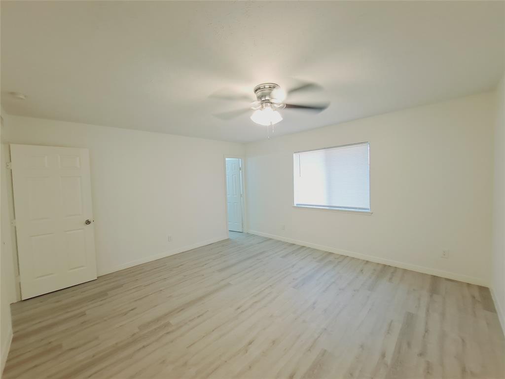 627 Valley View Drive Allen, TX 75002 - Photo 18 of 22 an empty room with wooden floor and ceiling fan