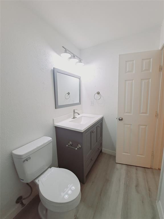 627 Valley View Drive Allen, TX 75002 - Photo 20 of 22 a bathroom with a toilet sink and mirror