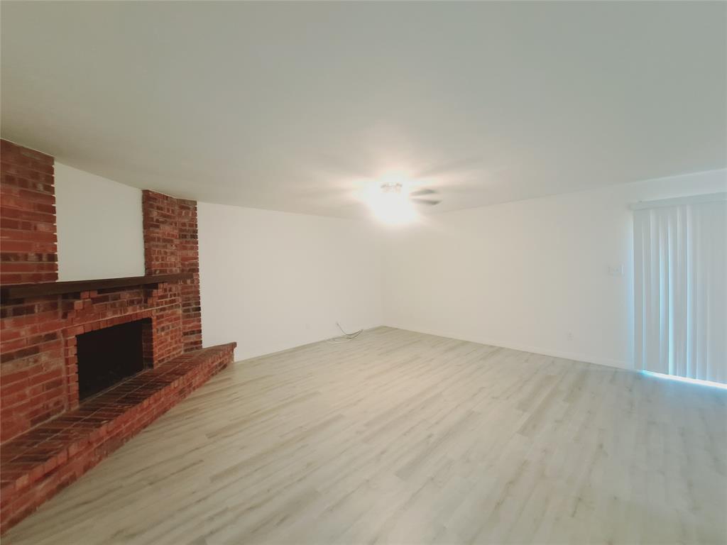 627 Valley View Drive Allen, TX 75002 - Photo 5 of 22 a view of empty room with wooden floor and fireplace