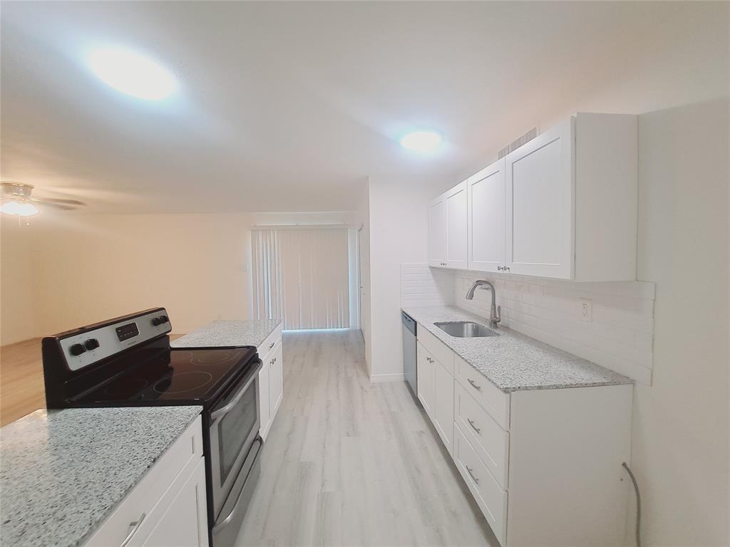 627 Valley View Drive Allen, TX 75002 - Photo 6 of 22 a kitchen with a sink stove and cabinets
