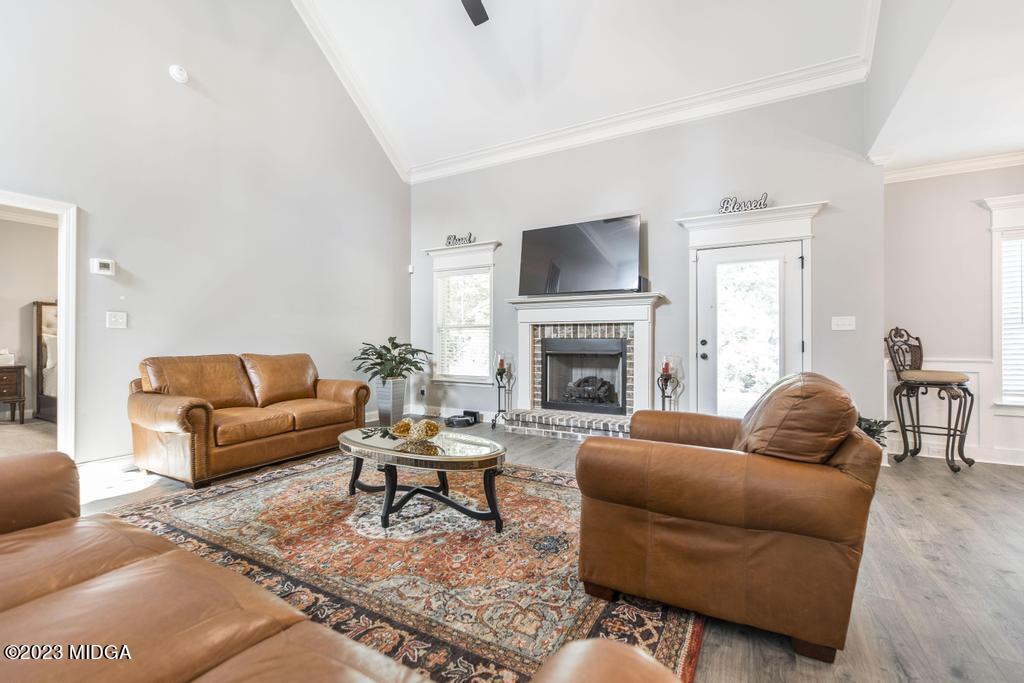 129 Timber Ridge Circle Byron, GA 31008 - Photo 11 of 42 a living room with furniture a fireplace and a flat screen tv