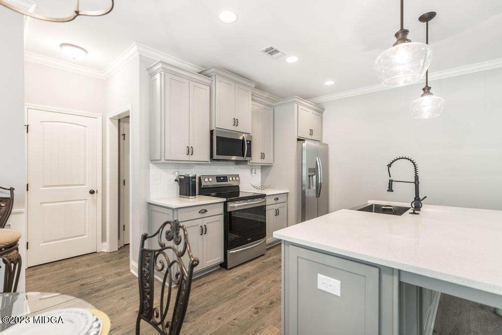 129 Timber Ridge Circle Byron, GA 31008 - Photo 14 of 42 a kitchen with a sink stainless steel appliances and white cabinets