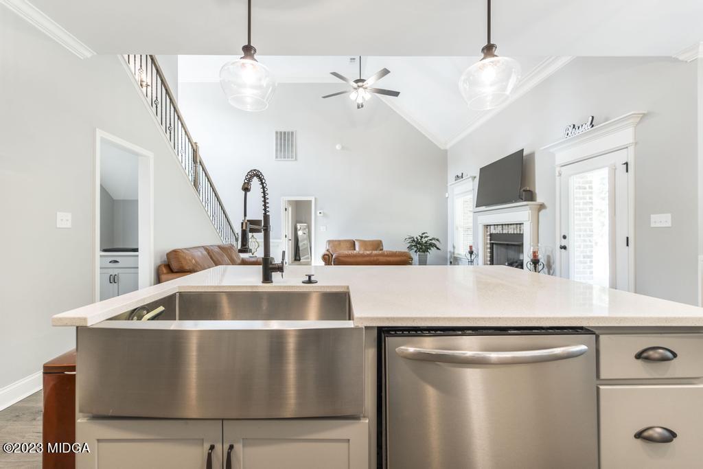 129 Timber Ridge Circle Byron, GA 31008 - Photo 16 of 42 a view of a kitchen with kitchen island a stove a sink dishwasher and wooden floor