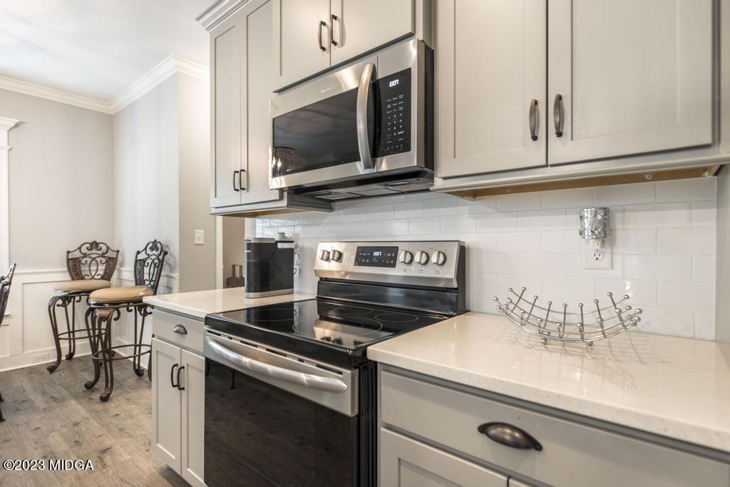 129 Timber Ridge Circle Byron, GA 31008 - Photo 17 of 42 a kitchen with a stove and a microwave