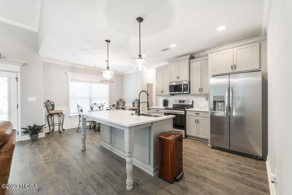 129 Timber Ridge Circle Byron, GA 31008 - Photo 18 of 42 a kitchen with kitchen island a white counter top space a sink appliances and cabinets