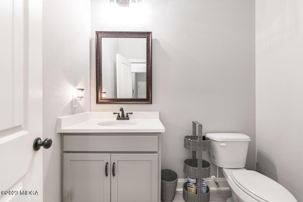 129 Timber Ridge Circle Byron, GA 31008 - Photo 19 of 42 a bathroom with a toilet sink and mirror