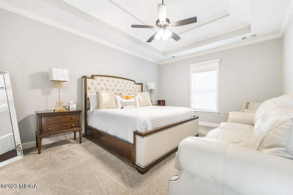 129 Timber Ridge Circle Byron, GA 31008 - Photo 22 of 42 a bedroom with a bed and a chandelier