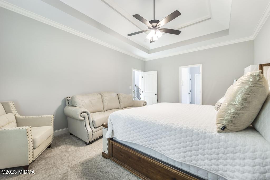 129 Timber Ridge Circle Byron, GA 31008 - Photo 23 of 42 a spacious bedroom with a bed and a chandelier