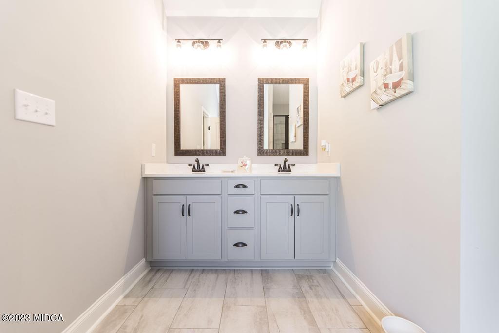 129 Timber Ridge Circle Byron, GA 31008 - Photo 27 of 42 a bathroom with a sink mirror and vanity