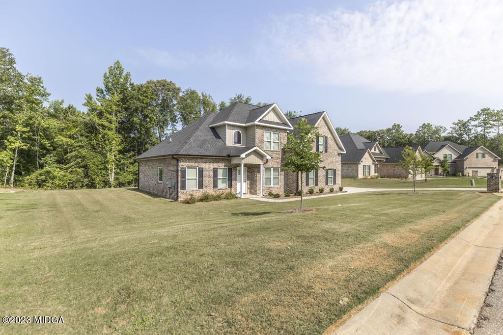 129 Timber Ridge Circle Byron, GA 31008 - Photo 3 of 42 a front view of a house with a yard