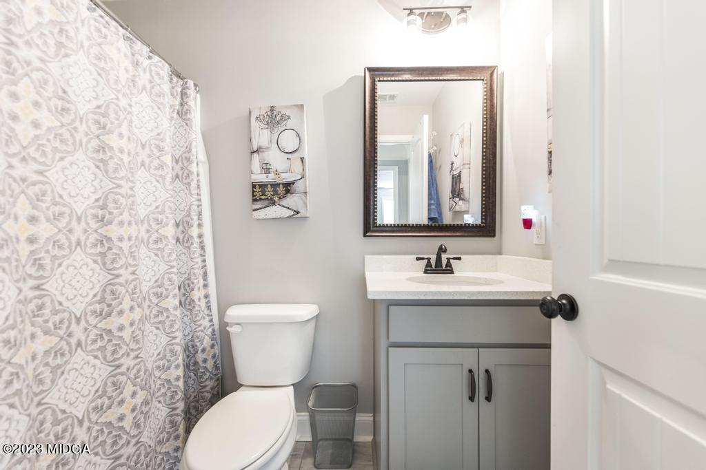 129 Timber Ridge Circle Byron, GA 31008 - Photo 33 of 42 a bathroom with a toilet sink and mirror