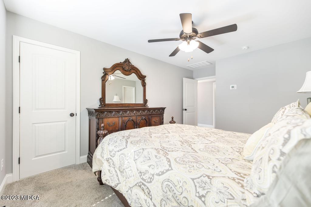 129 Timber Ridge Circle Byron, GA 31008 - Photo 35 of 42 a bedroom with a bed and a ceiling fan