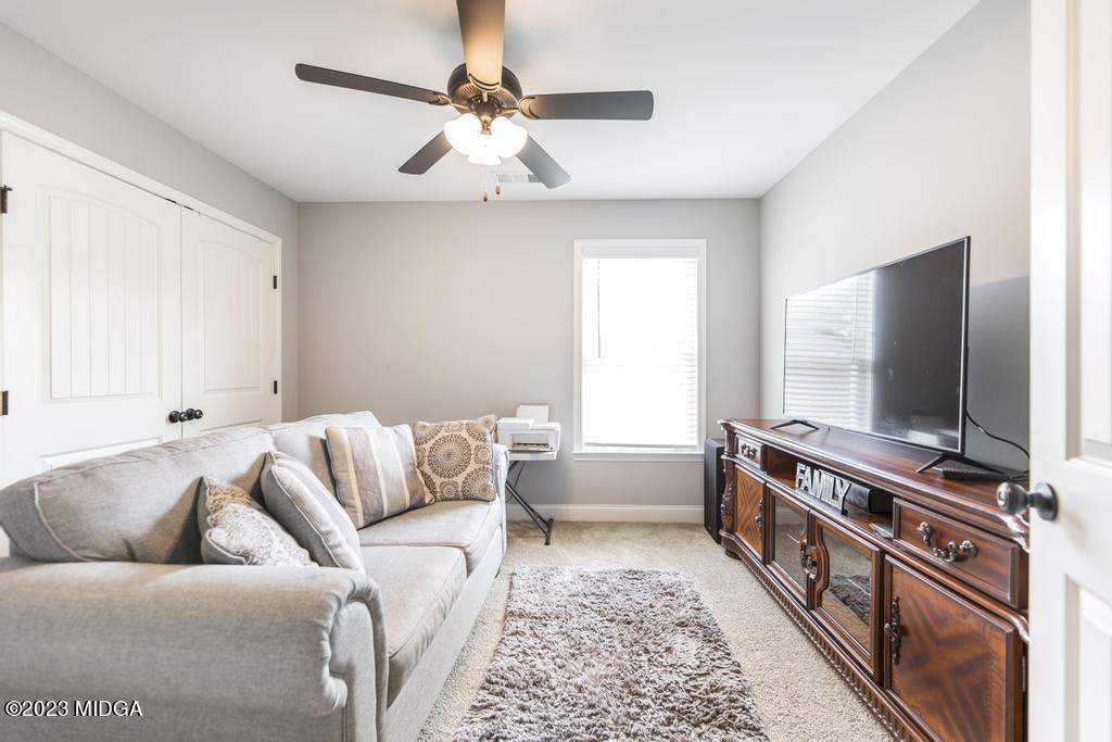 129 Timber Ridge Circle Byron, GA 31008 - Photo 36 of 42 a living room with furniture and a flat screen tv