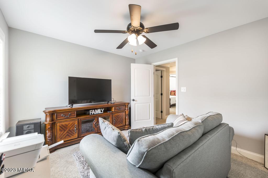129 Timber Ridge Circle Byron, GA 31008 - Photo 37 of 42 a living room with furniture and a flat screen tv