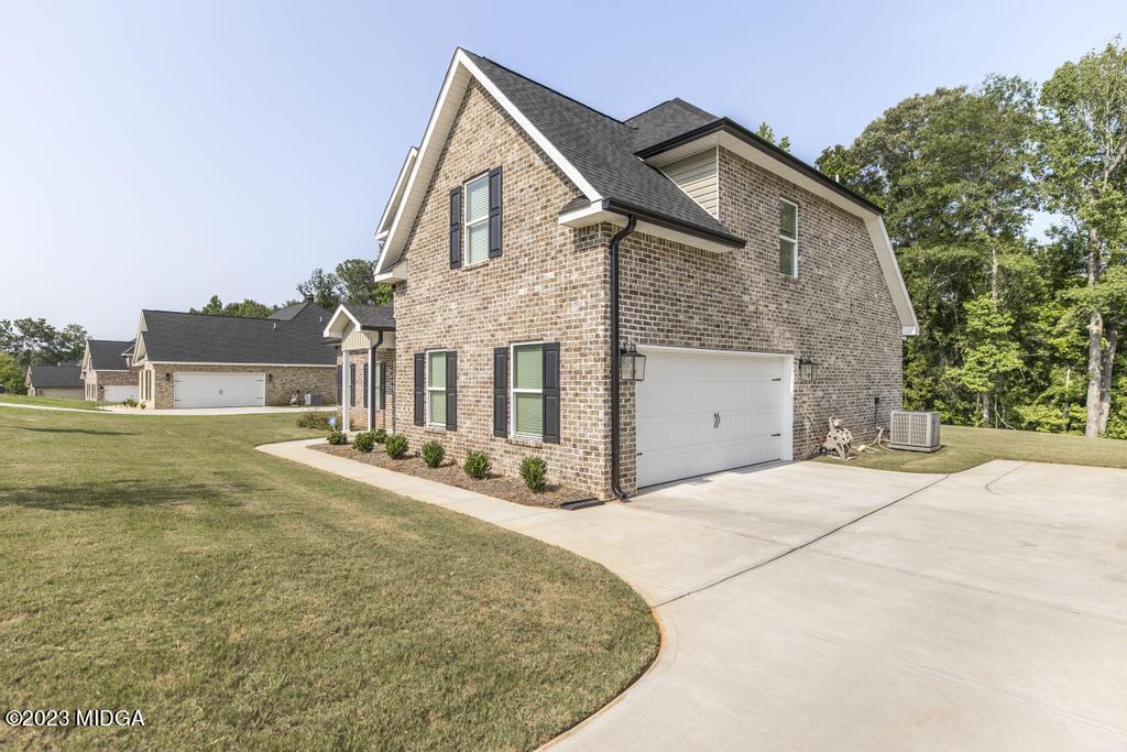 129 Timber Ridge Circle Byron, GA 31008 - Photo 5 of 42 a front view of a house with a yard