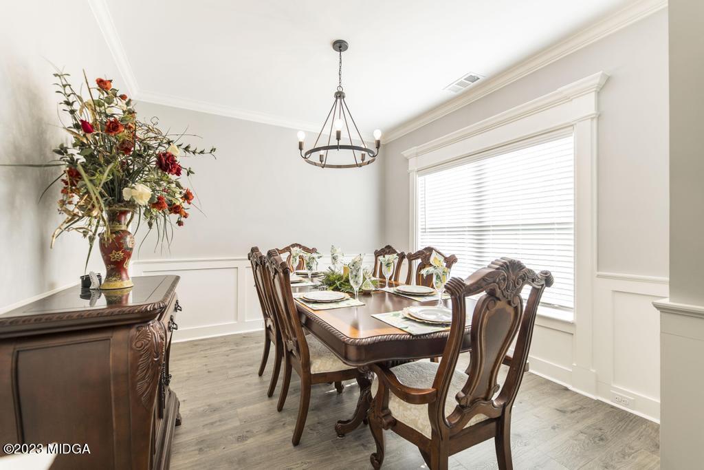 129 Timber Ridge Circle Byron, GA 31008 - Photo 8 of 42 a dining room with furniture potted plants and wooden floor