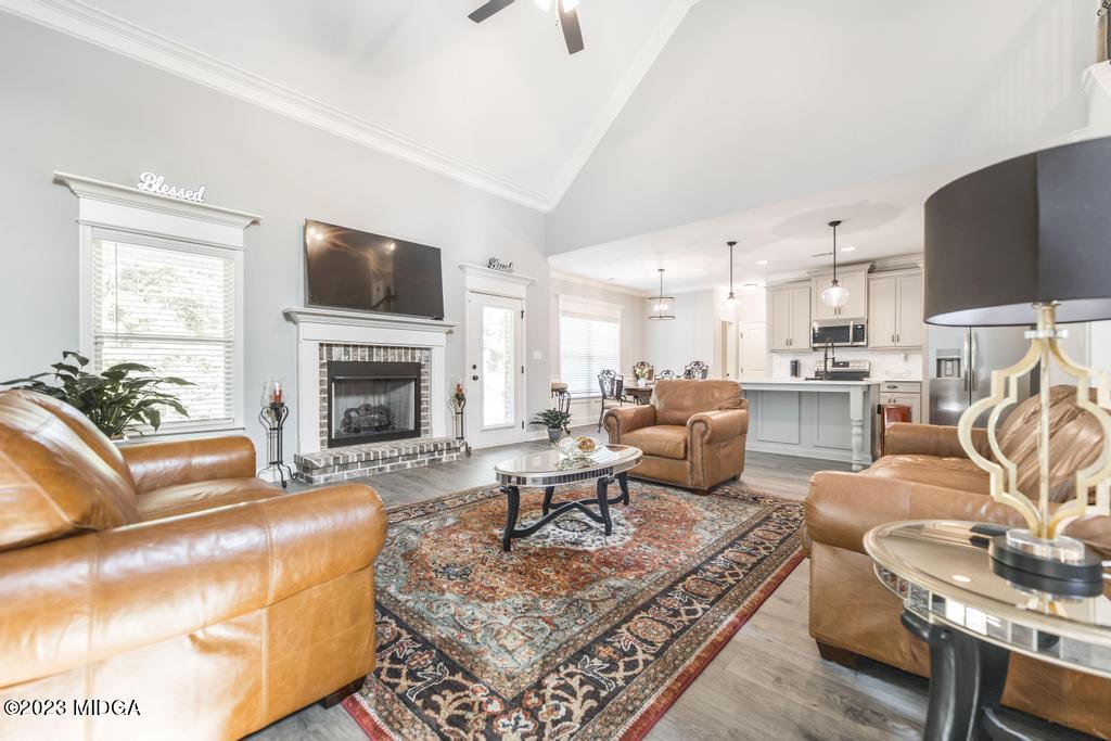 129 Timber Ridge Circle Byron, GA 31008 - Photo 9 of 42 a living room with furniture a flat screen tv and a fireplace