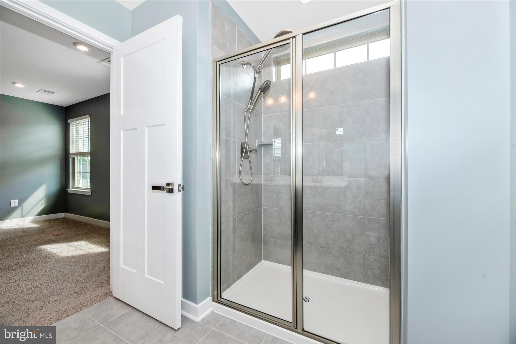 7091 Kokanee Way New Market, MD 21774 - Photo 28 of 69 a bathroom with a glass shower door