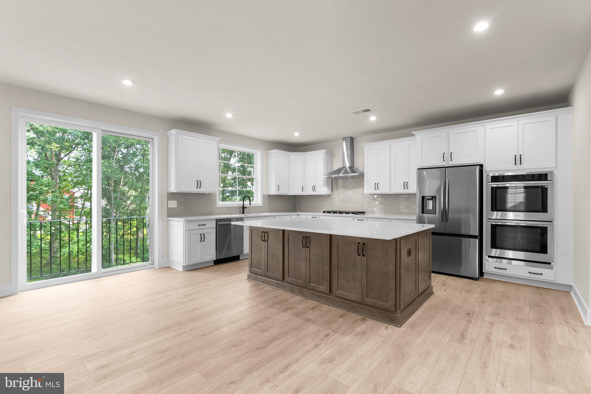 104 Alabaster Lane Stephenson, VA 22656 - Photo 11 of 48 a kitchen with stainless steel appliances kitchen island granite countertop a stove a sink and a refrigerator
