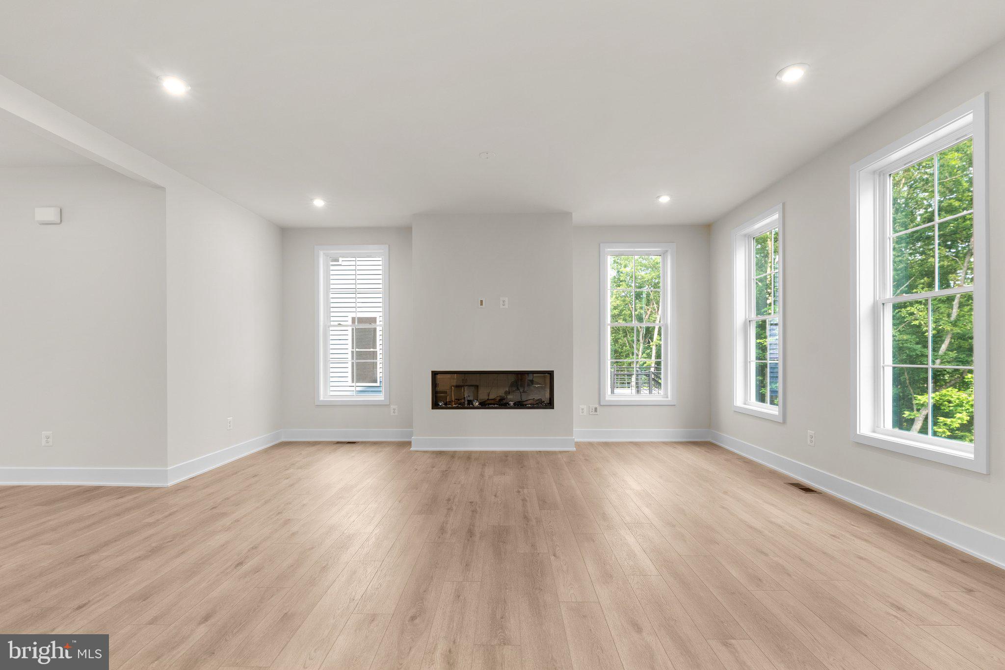 104 Alabaster Lane Stephenson, VA 22656 - Photo 19 of 48 an empty room with wooden floor and windows