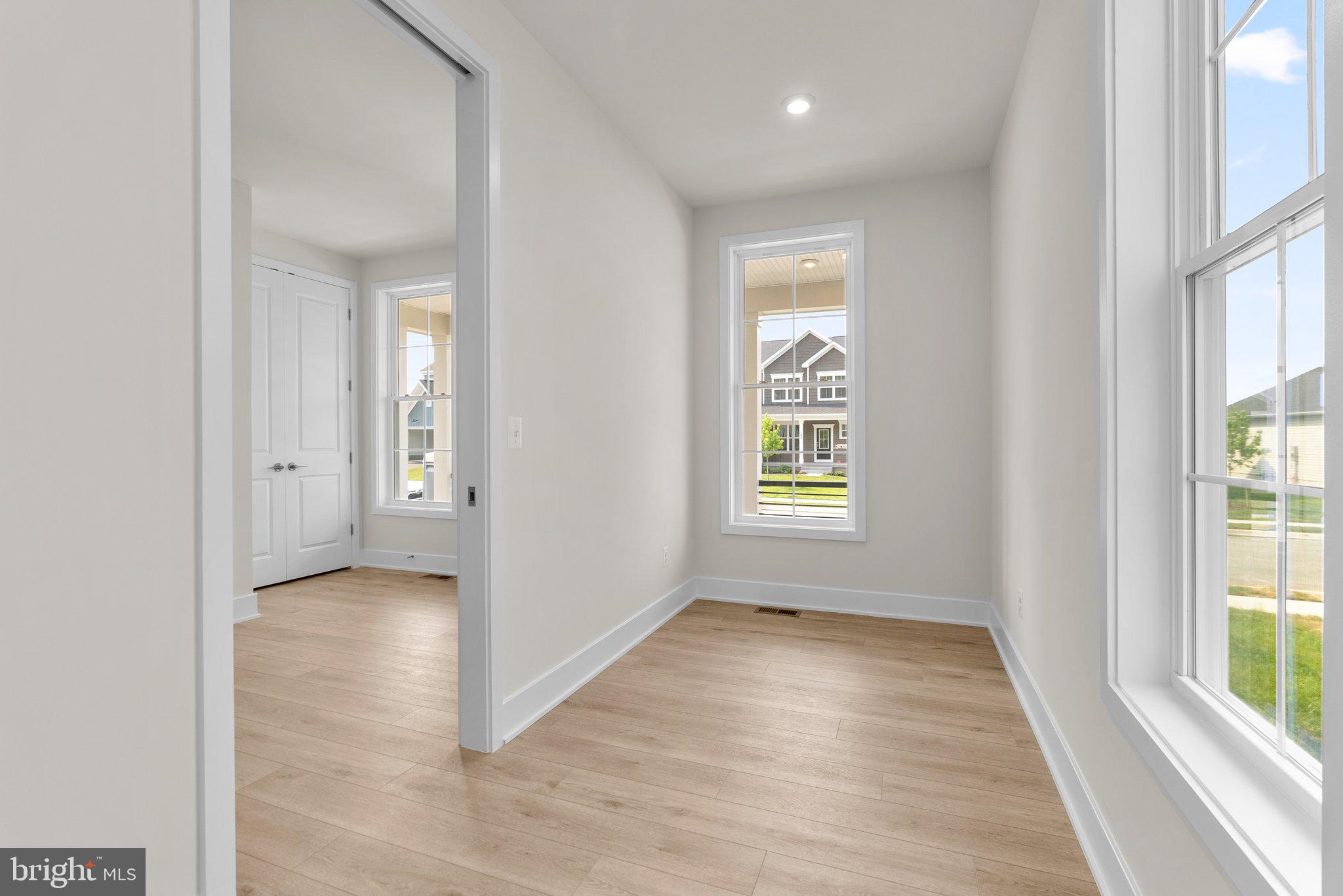 104 Alabaster Lane Stephenson, VA 22656 - Photo 23 of 48 an empty room with wooden floor and windows