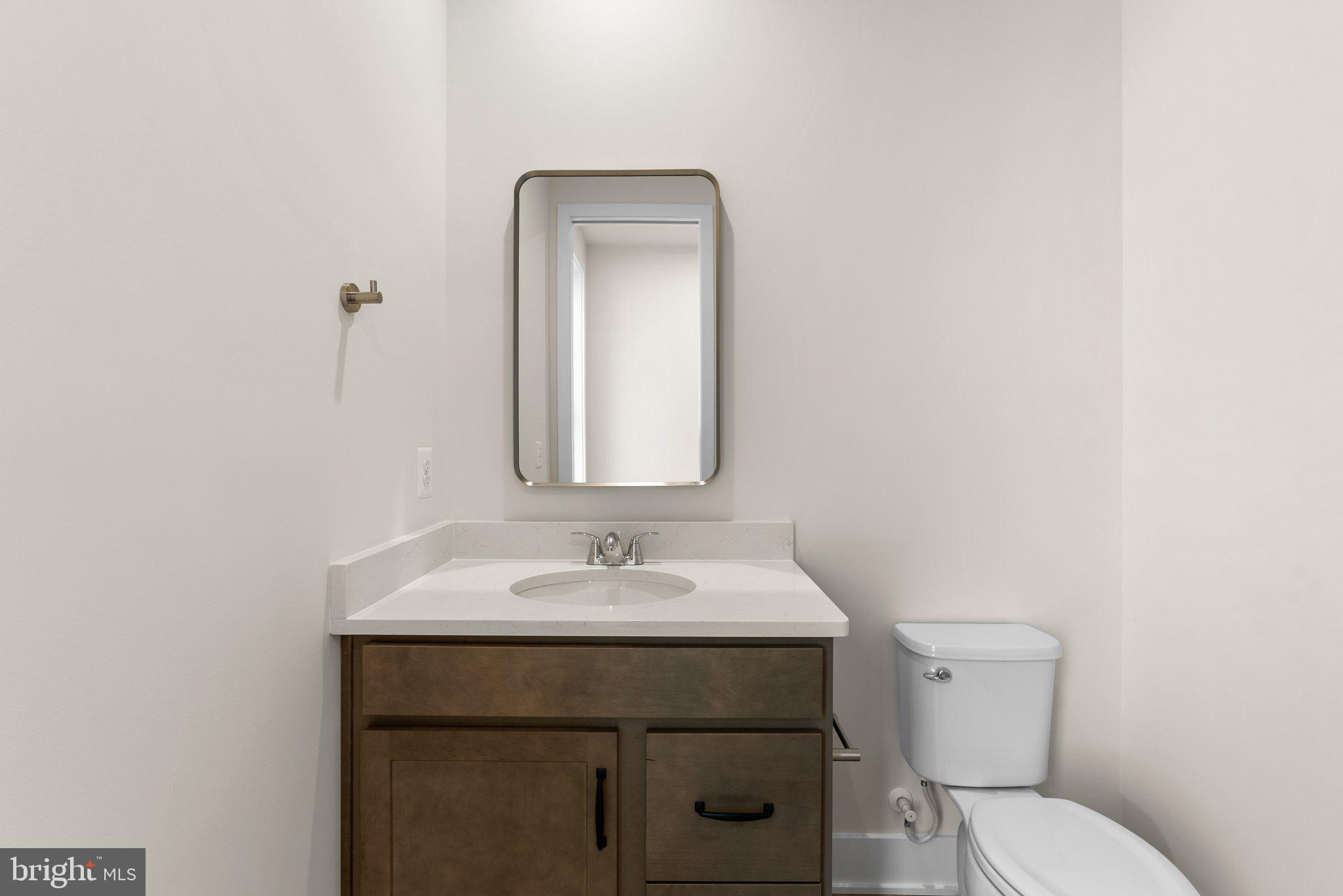 104 Alabaster Lane Stephenson, VA 22656 - Photo 24 of 48 a bathroom with a toilet sink and mirror