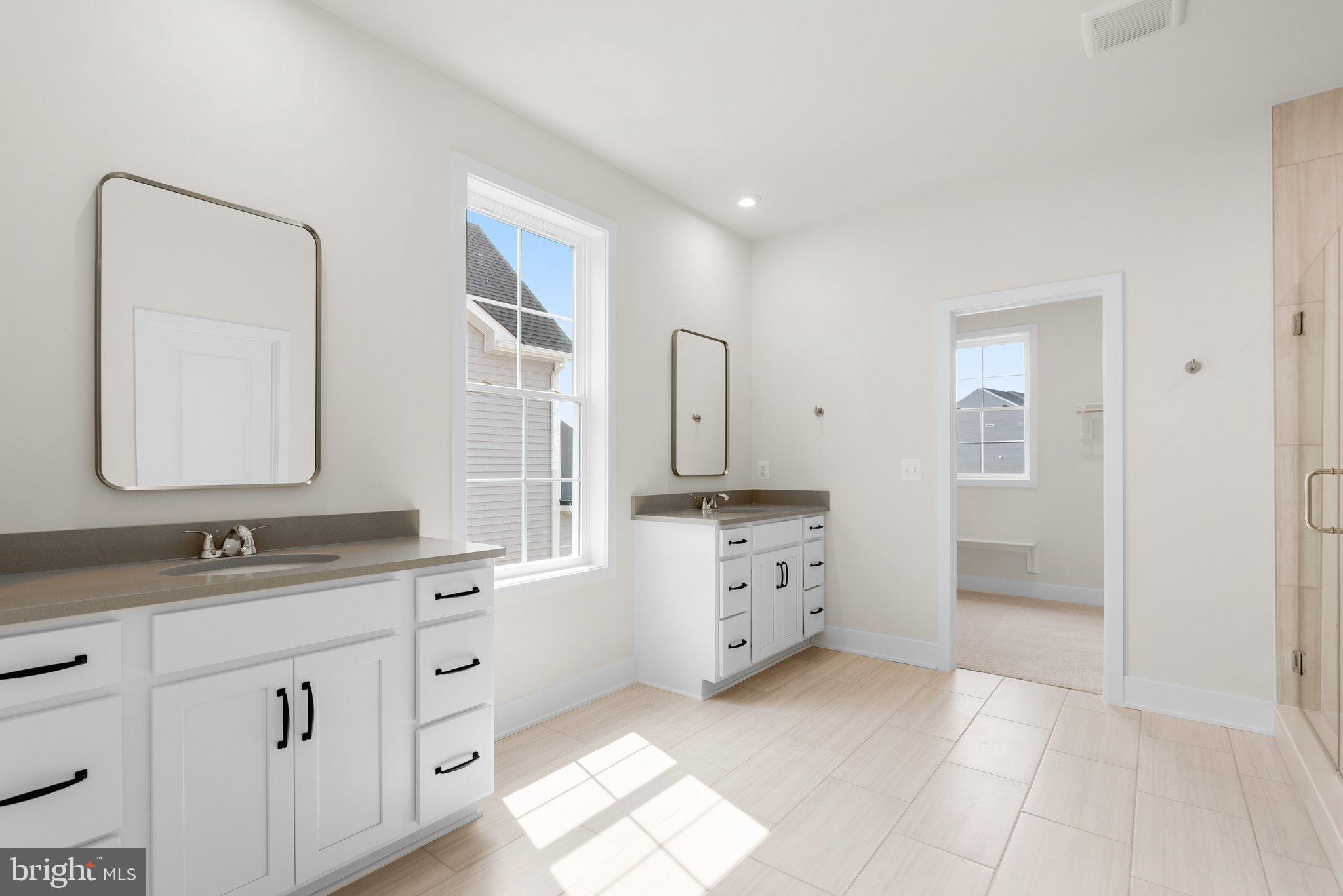 104 Alabaster Lane Stephenson, VA 22656 - Photo 28 of 48 a spacious bathroom with a double vanity sink mirror and