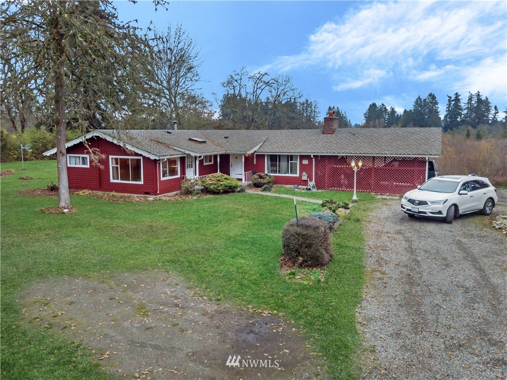 16407 Spanaway Loop Road South Spanaway, WA 98387 - Photo 4 of 20 a front view of a house with a garden and trees