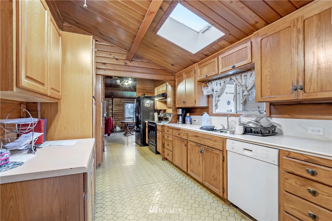 16407 Spanaway Loop Road South Spanaway, WA 98387 - Photo 6 of 20 a kitchen with stainless steel appliances granite countertop a sink and cabinets