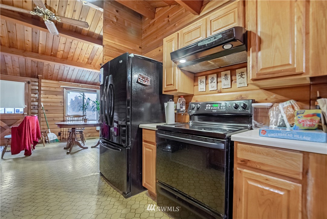 16407 Spanaway Loop Road South Spanaway, WA 98387 - Photo 9 of 20 a kitchen with a stove and a refrigerator