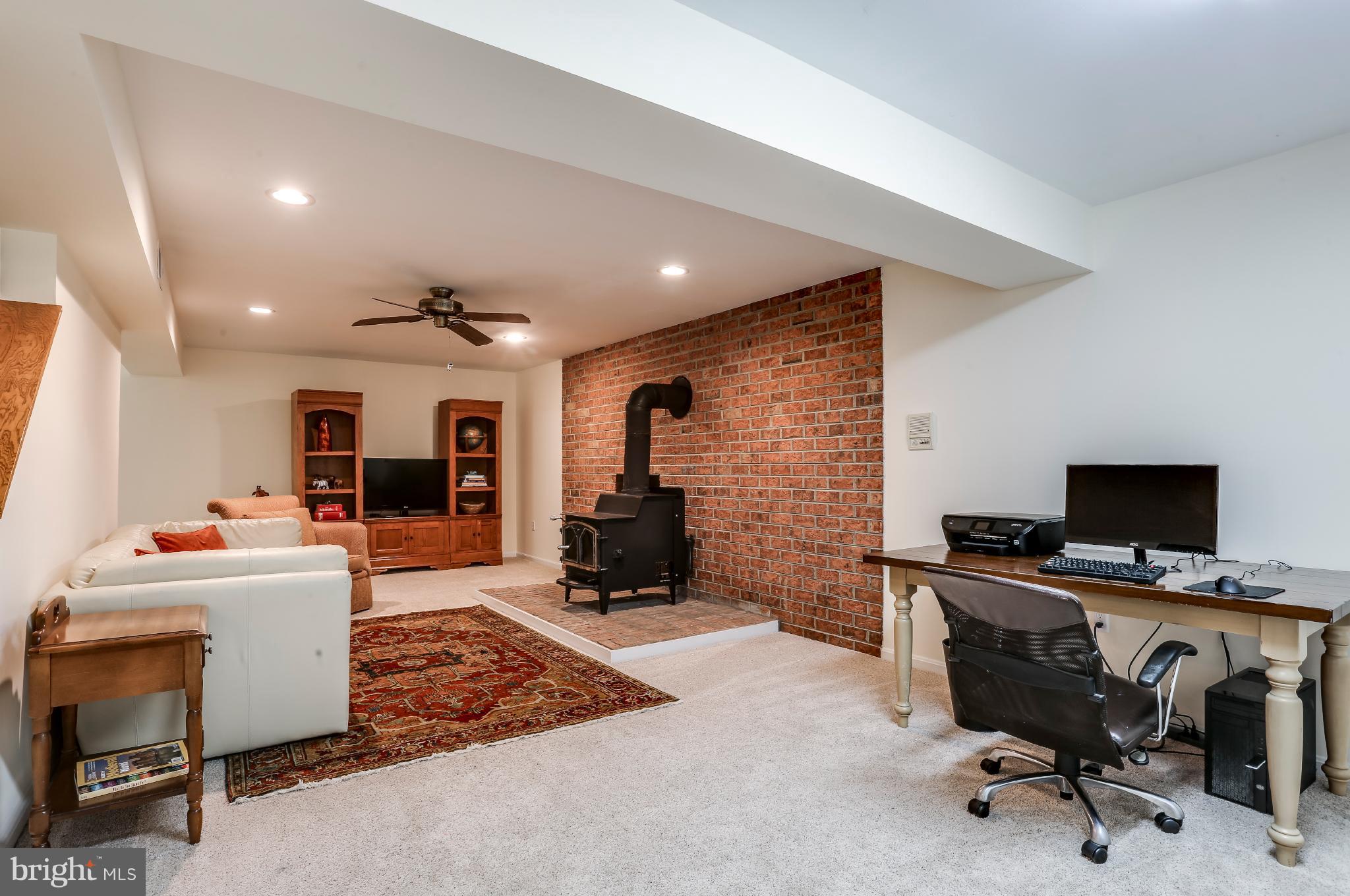 7113 Rivers View Court Columbia, MD 21044 - Photo 22 of 27 Rec Room with woodburning stove