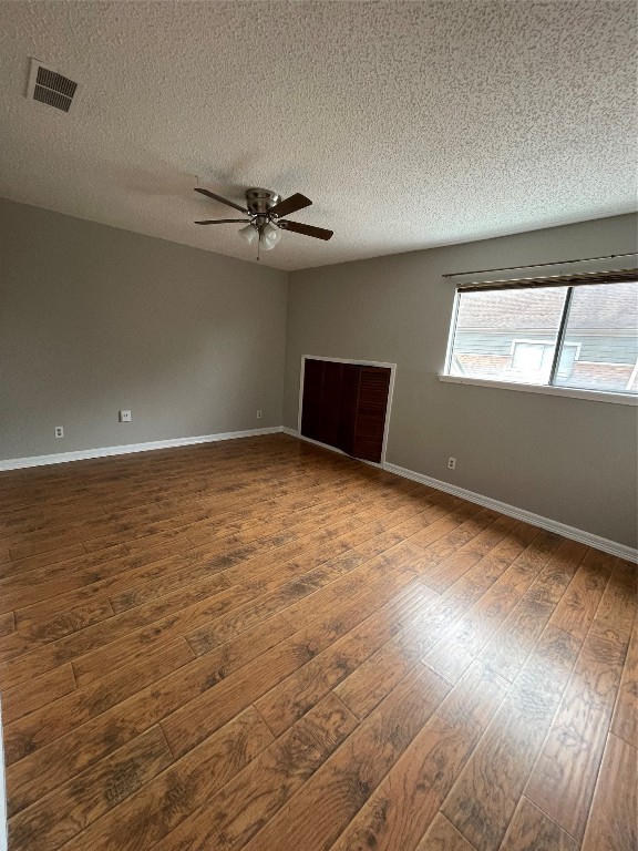 6601 Sands Point Drive, Unit 63 Houston, TX 77074 - Photo 11 of 18 an empty room with wooden floor and windows