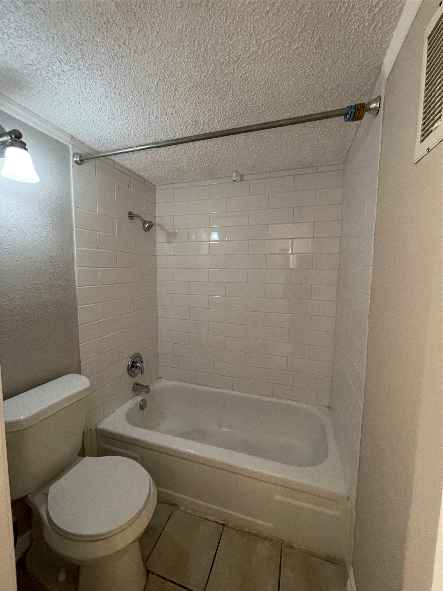 6601 Sands Point Drive, Unit 63 Houston, TX 77074 - Photo 13 of 18 a white toilet sitting next to a bath tub