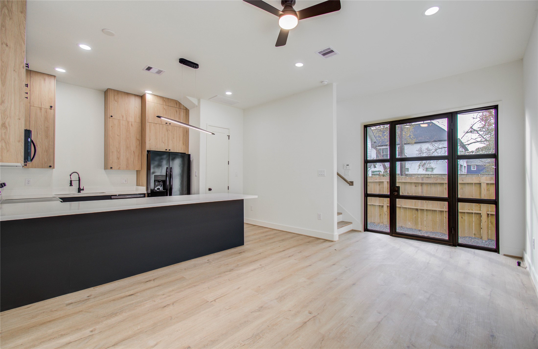 1815 McKee Street, Unit 1 Houston, TX 77009 - Photo 11 of 25 a large kitchen with stainless steel appliances a large counter top a refrigerator and a sink