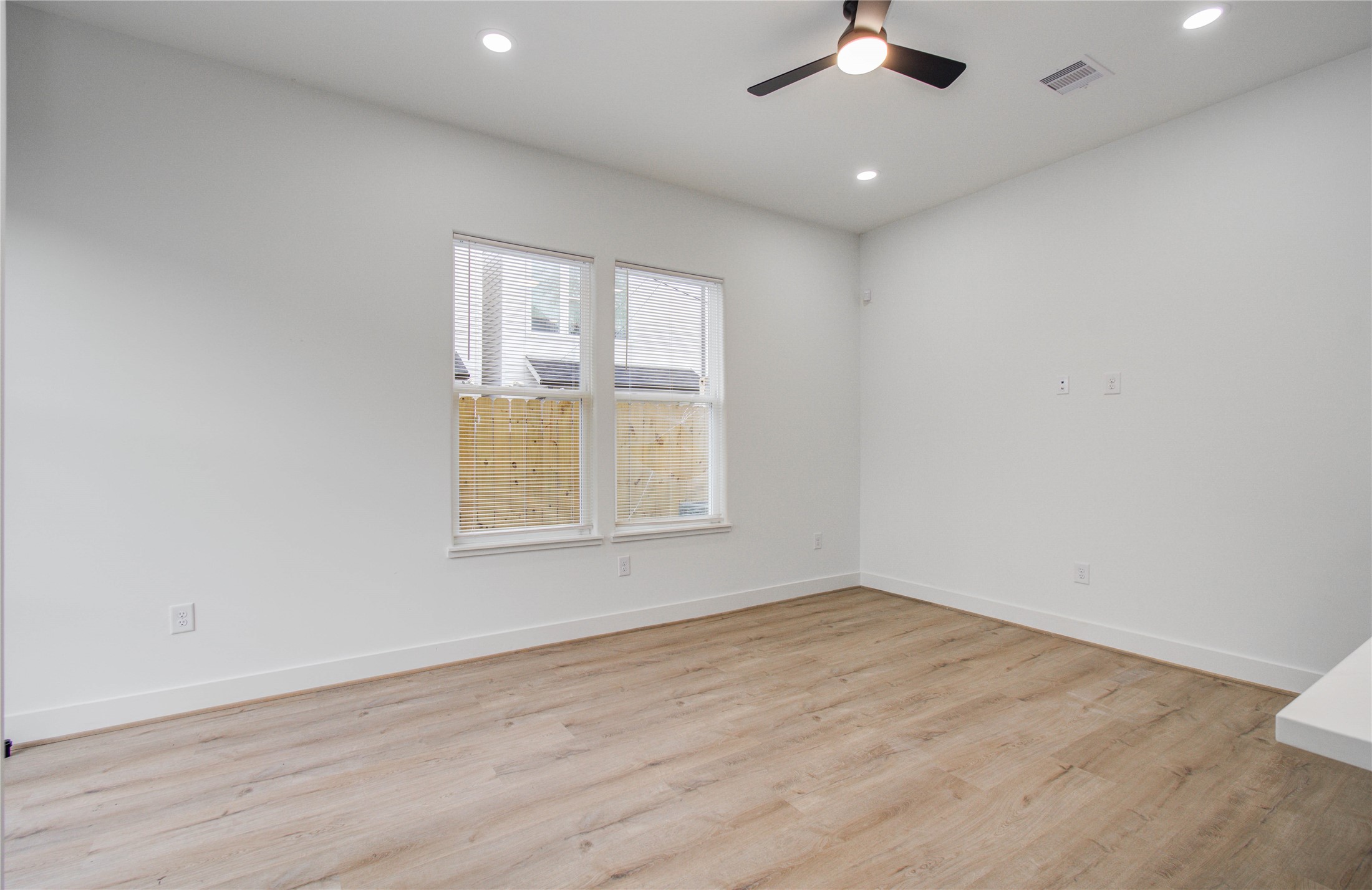 1815 McKee Street, Unit 1 Houston, TX 77009 - Photo 13 of 25 wooden floor in an empty room with a window