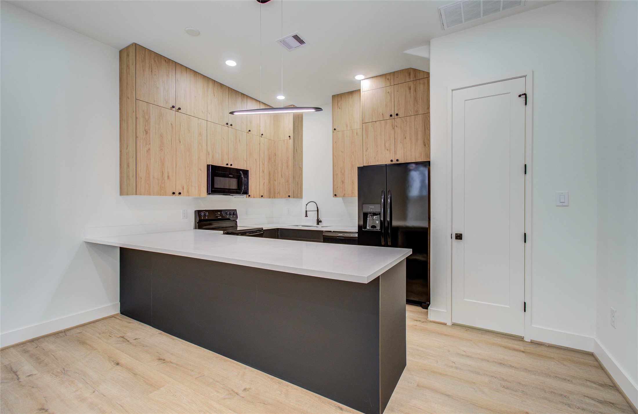 1815 McKee Street, Unit 1 Houston, TX 77009 - Photo 14 of 25 a kitchen with stainless steel appliances a sink stove and refrigerator