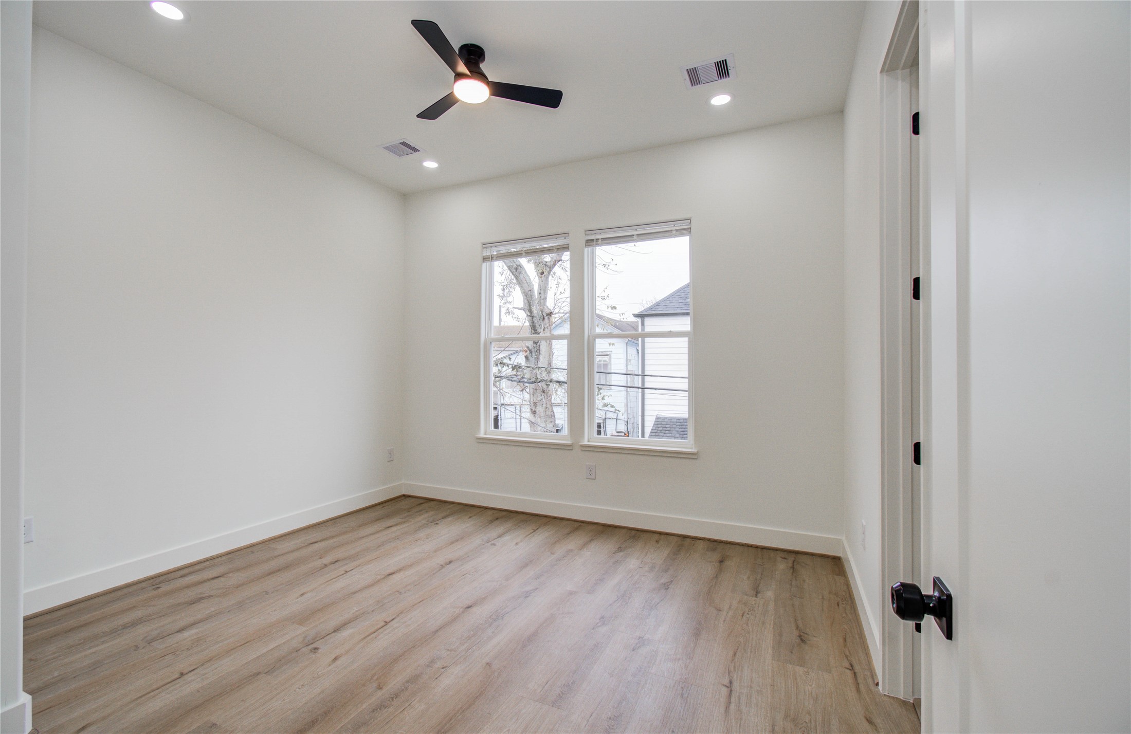 1815 McKee Street, Unit 1 Houston, TX 77009 - Photo 19 of 25 a view of an empty room with wooden floor and a window